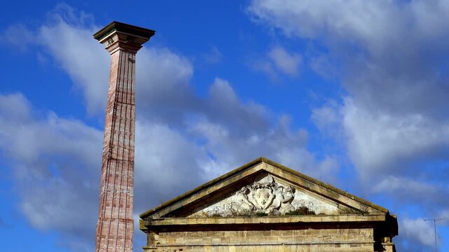 stone column and pediment in Bordeaux Justice under blue sky with clouds 