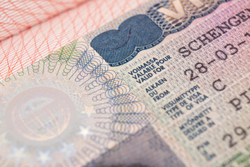 Schengen visa of Finland on the page of the passport. Part of suomi shengen visa close up
