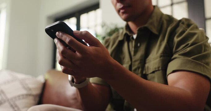 Hands, phone and texting on sofa, relax and check notification for web chat in living room at house. Person, smartphone and scroll with mobile app, contact and low angle for social media at apartment