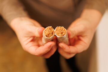 Hands holding traditional alfajor medina sidonia dessert cut open