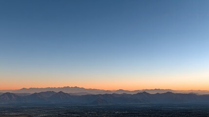 Fototapeta premium Colors blend beautifully in the sky as the sun rises over the horizon, casting a vibrant glow across the clouds
