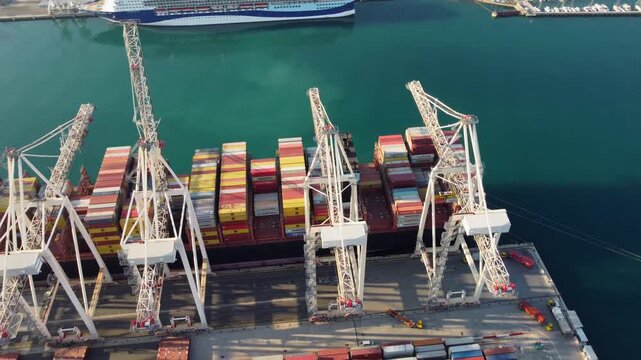 Aerial view of a cargo ship docked at the port to load and unload containers. The Port of Koper is an industrial hub in the Mediterranean