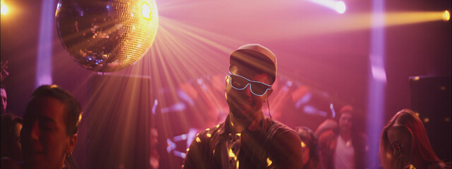 Celebration at a vibrant dance club with disco lights and energetic crowd on a lively night