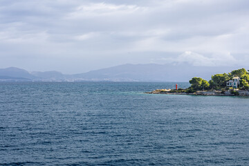 Coastal Seascape With Small Island, Lighthouse, and House Along Calm Blue Sea, Rogac, Croatia