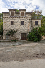 Rustic Stone Building With Green Shutters Under Clear Blue Sky, Old Town Charm, Rogac, Croatia
