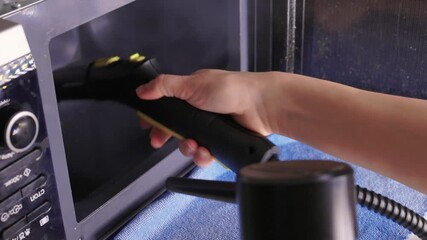 Cleaning microwave safely, Handheld steamer removes grime from microwave cavity efficiently, Ecofriendly steam cleaning method focuses on hygiene and appliance preservation