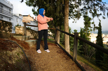 Arab Muslim Woman in Hijab Enjoying a Walk on a Scenic European Park Path