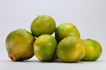 A Heap Of Green Tangerines, A Specific Variety Of Mandarin Oranges That Remain Green When Ripe. The Fruits Are Sweet And Ready To Eat Despite Their Color.
