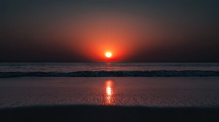 Dramatic sunset over a tranquil ocean shore.