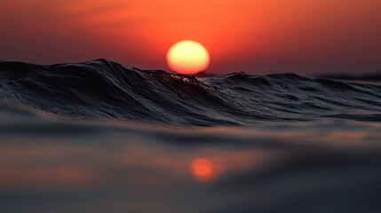 Fiery sunset over rippling water's edge.