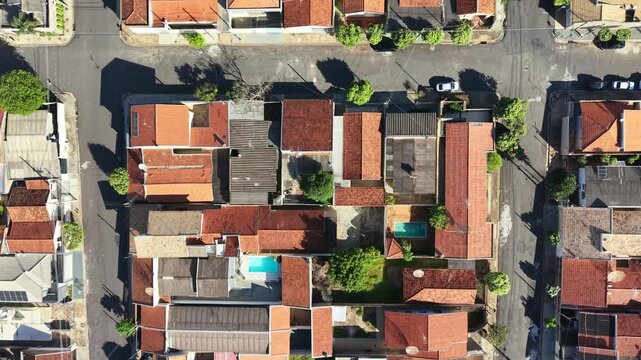 Aerial view showcases residential neighborhood with pools and rooftops