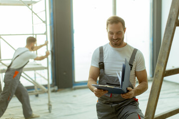 Construction workers collaborating on a renovation project in a modern building