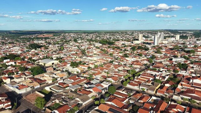 Aerial view showcases a sprawling urban landscape under a blue sky day