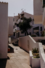 Traditional white houses and narrow streets of Binib&egrave;quer Vell, a picturesque fishing village in Menorca, Spain. Mediterranean charm.