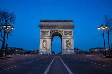 Arc de Triomphe monument on the Champs Elysees avenue in Paris at the blue hours night