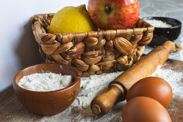  Cake baking products presented on a rustic wooden surface dusted with flour. Perfect for cooking magazines and culinary promotions.