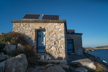 Stone building with solar panels near Cape Tainaron Lighthouse in Mani, Greece
