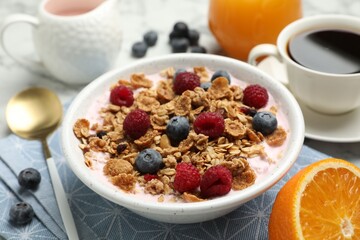 Tasty breakfast. Granola with yogurt and fruits served on table, closeup