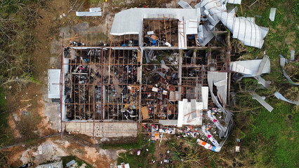 Aerial view of a destroyed house with debris scattered around the damaged structure