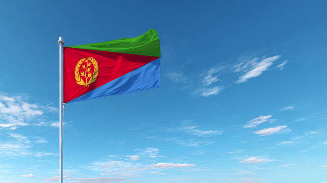 Eritrean flag waving against a clear blue sky during daylight hours - Powered by Adobe