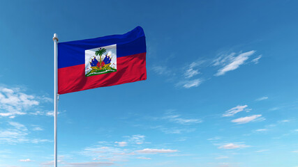 Haitian flag waving under a clear blue sky representing national pride and sovereignty