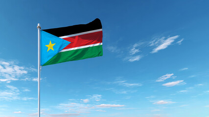 South Sudan flag waving proudly against a clear blue sky, symbolizing sovereignty and national pride