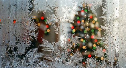 Frost patterns on window with blurred Christmas lights
