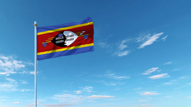 Celebrating independence with the national flag of Eswatini against a clear, blue sky