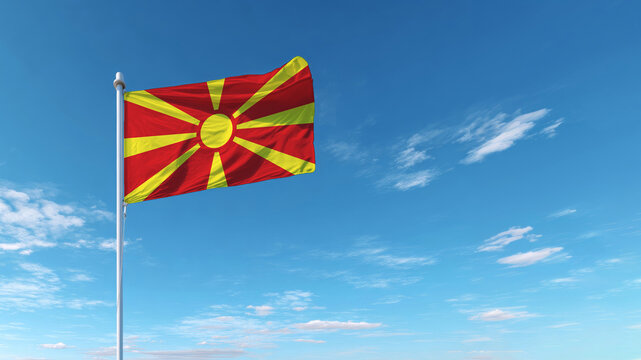 Celebrating north macedonia's independence day with the national flag against a blue sky - Powered by Adobe