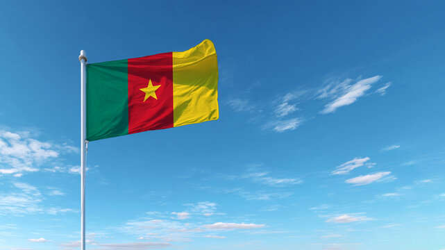 Cameroon flag waving proudly against a clear blue sky at midday signifying independence and national pride