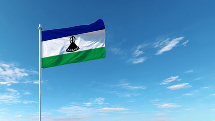 Sovereign flag of Lesotho waving under a clear blue sky during a sunny day