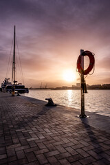 Beautiful sunset sky in the marina bay of Malaga city. Amazing colorful seascape.