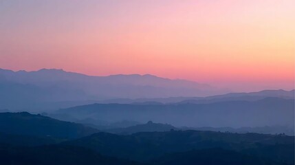 Fototapeta premium Sunrise over misty mountain landscape with forest and valley view