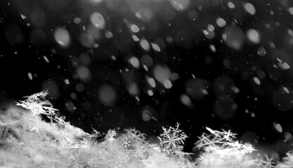 Snowdrift with snowflakes against the background of falling snow and bokeh, isolated on black...