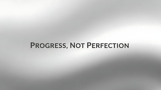 Progress not perfection text displayed on a blurred gradient background with light and dark shades