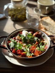 Rustic Skillet Dish with Fresh Herbs and Sunlit Table Setting