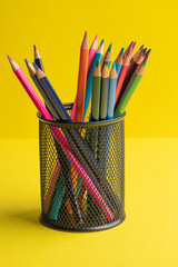 colored pencils on a yellow background