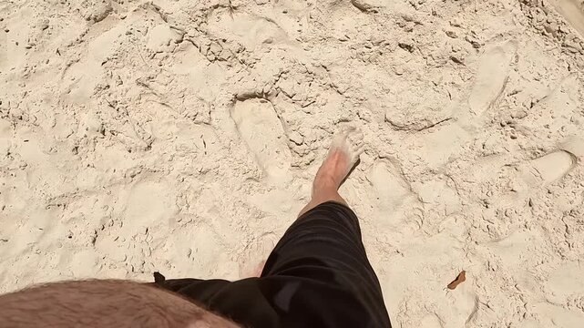 A man's point of view walking on a beach in Porto Belo, Brazil on a summer day.