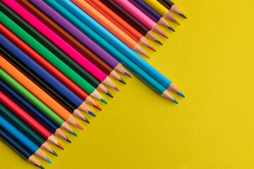 colored pencils on a yellow background