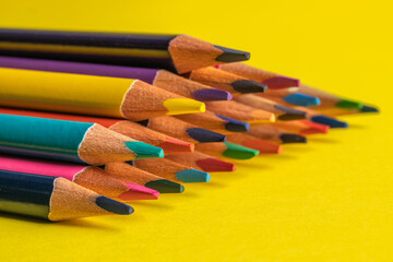 Fototapeta premium colored pencils on a yellow background