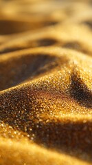 Golden sand dunes shimmering in the sunlight create abstract texture