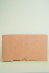 Mock-up of recycled eco friendly cardboard box, product and paracel packaging isolated on green background. Vertical orientation.