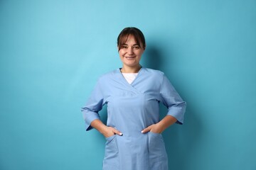Doctor in medical uniform on light blue background