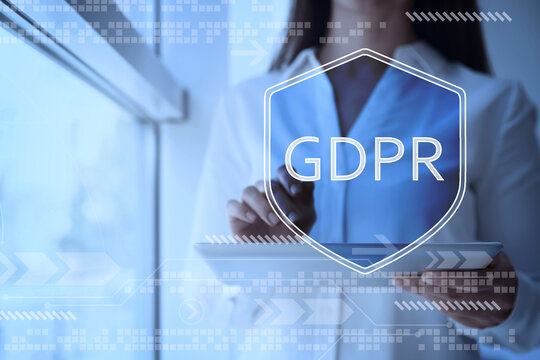 General Data Protection Regulation, virtual shield with GDPR. Woman using tablet computer, closeup. Privacy security
