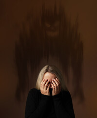 Phobia, suffering from pathological fear. Scared woman covering her eyes. Terrifying monster on brown background behind her