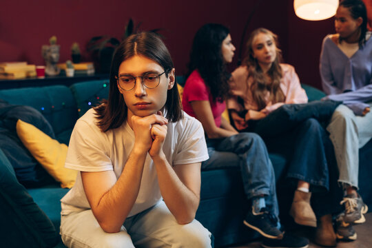 Young man feeling left out and isolated from group