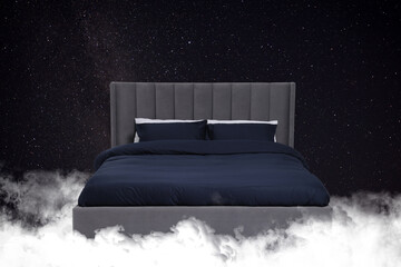 Fototapeta premium Large bed on fluffy clouds in starry night sky