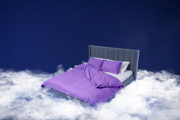 Fototapeta premium Large bed on fluffy clouds in starry night sky