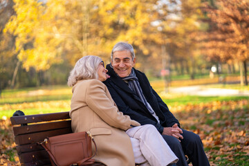 Happy senior couple enjoying a relaxing day at the park in autumn