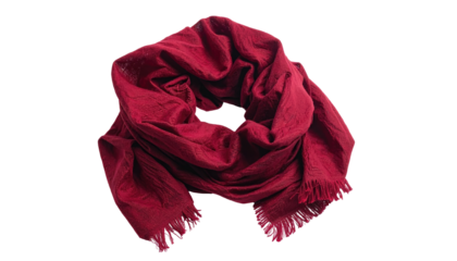 A cranberry-colored, soft scarf is artfully draped against a black background. Its texture appears slightly wrinkled, with fringe detail